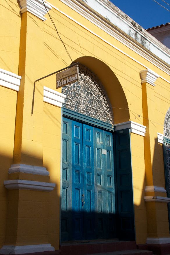 The warm sun hits a colorful building in Trinidad, Cuba