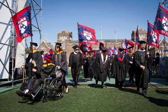 Harry Gross, W'44, leading the alumni flags onto Franklin Field for the University of Pennsylvania's Commencement, May 2014. Photo copyright: University of Pennsylvania.