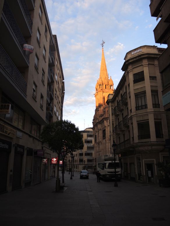 Golden morning light makes the top of this Salamanca church glow.